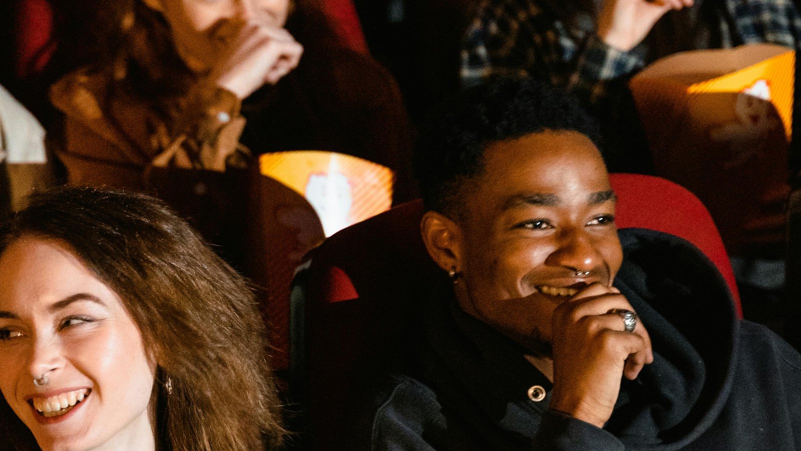 An audience genuinely enjoying a film together. Real engagement is the outcome of cultural localization done well. LCOM Translations.
